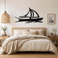 Black metal sailboat wall art with motion-line cutouts, mounted above a bed in a neutral bedroom.