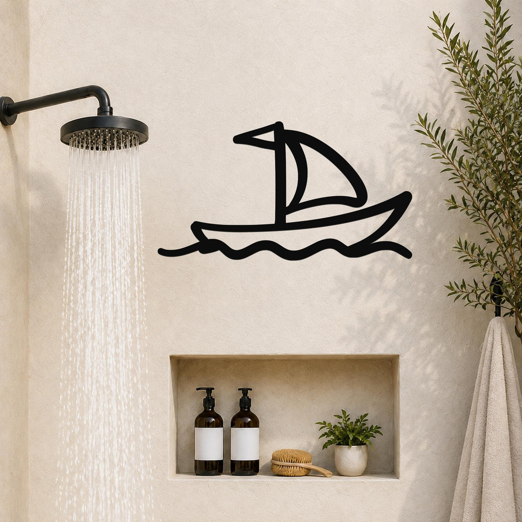 Black metal sailboat wall art with wave cutouts, mounted on a bathroom wall above a built-in shelf.