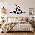 Black metal sailboat wall art with wave cutouts, mounted above a wooden bed in a neutral bedroom.