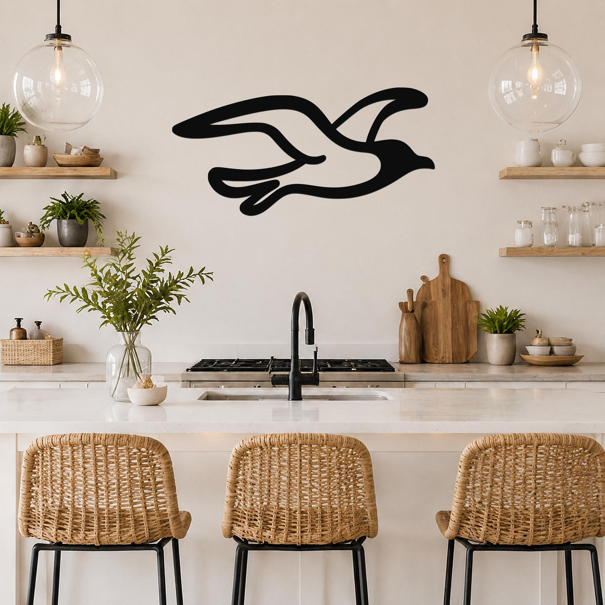 Black metal seagull wall art with flowing wing cutouts, mounted above a kitchen counter in a coastal-style kitchen.
