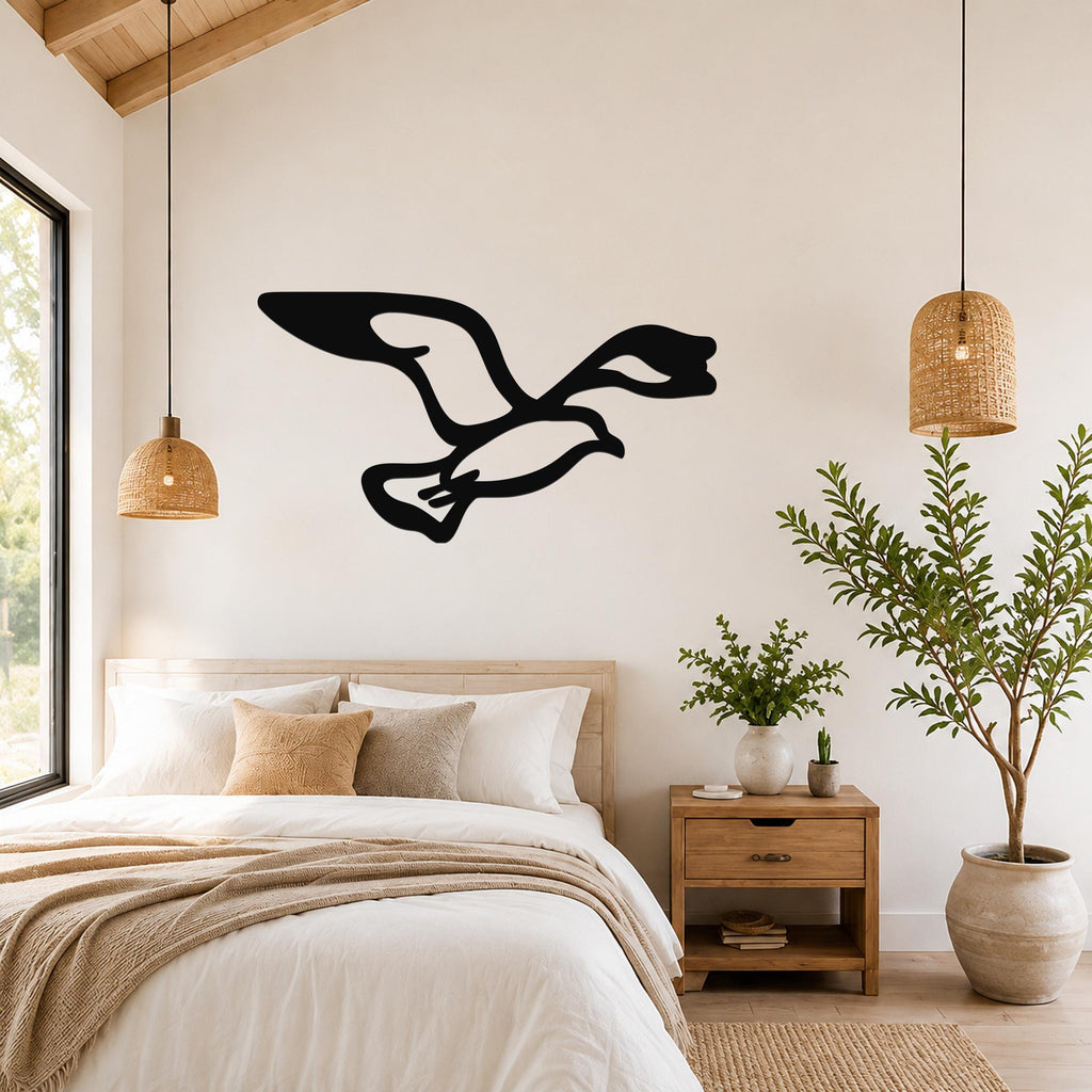 Black metal seagull wall art with motion-line cutouts, mounted above a bed in a bright bedroom.
