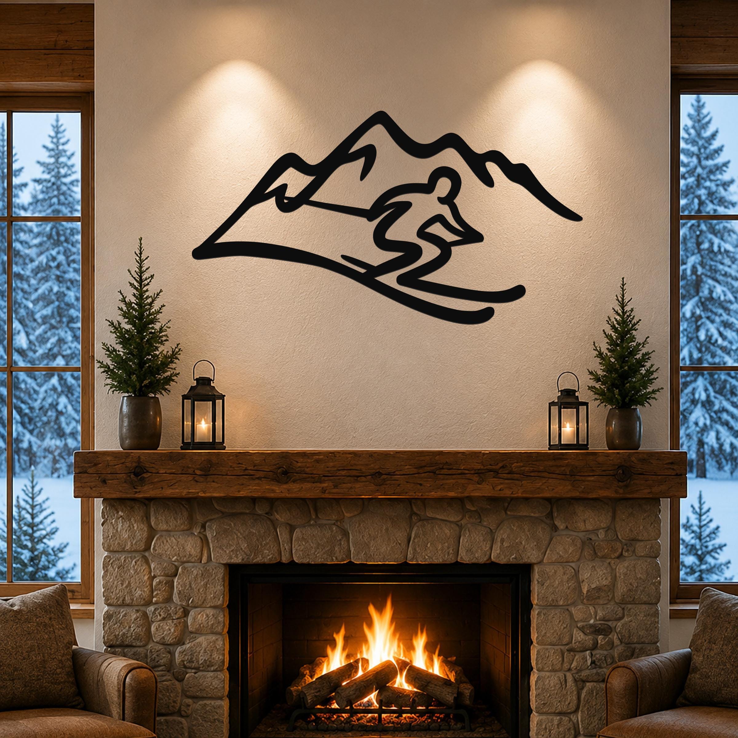 Black metal skier and mountain wall art with a dynamic silhouette, mounted above a stone fireplace in a cozy living room.