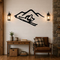 Black metal wall art featuring a skier silhouette in motion against mountain peaks, mounted on a shiplap wall above a wooden console table in a rustic living room.