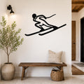 Black metal skier silhouette wall art with motion-line cutouts, mounted on a white wall above a wooden bench in a modern entryway.
