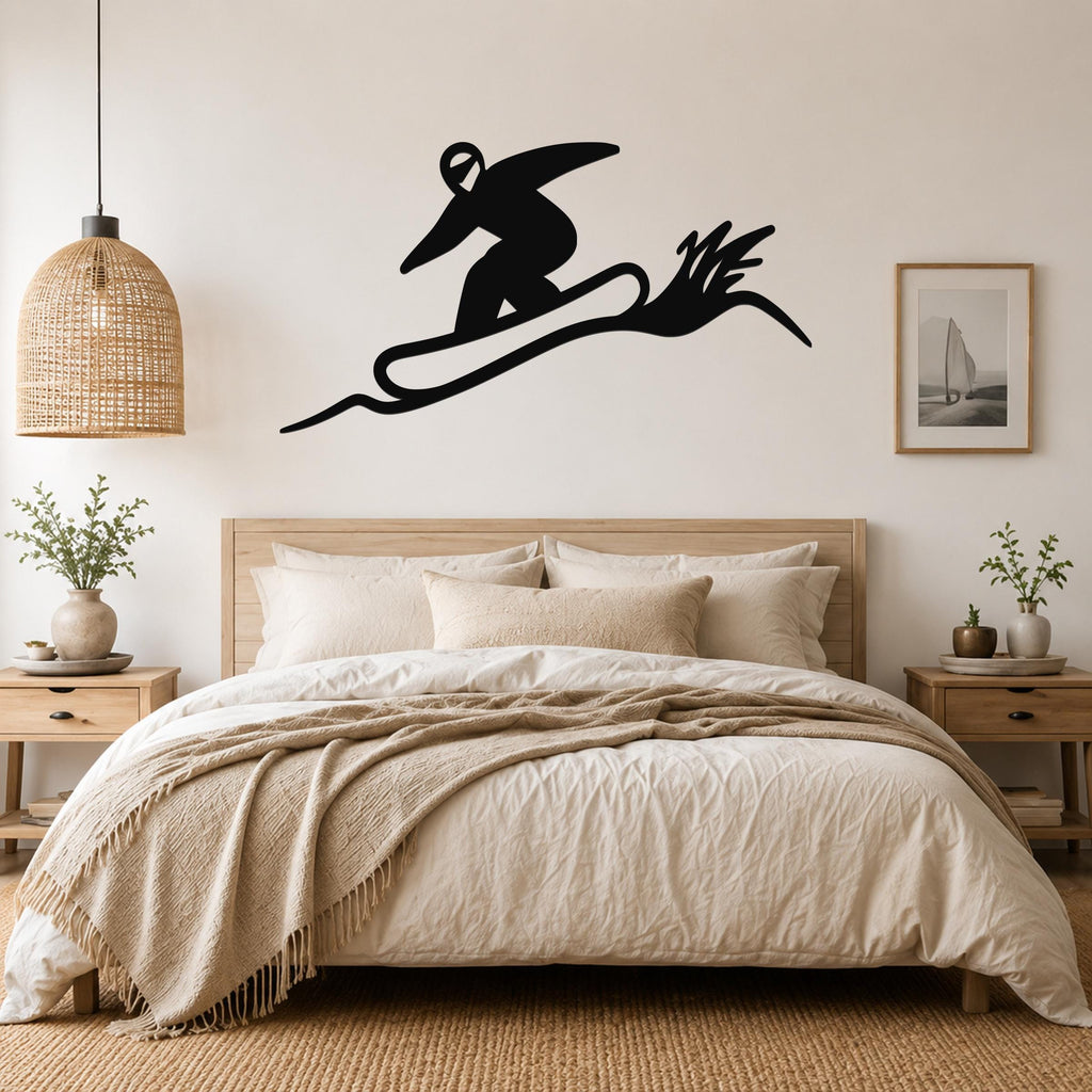 Black metal wall sculpture of a snowboarder in motion, mounted above a bed in a bedroom.