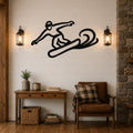 Black metal snowboarder silhouette wall art with motion lines, mounted on a shiplap wall above a wooden console table in a living room.