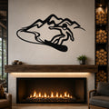 Black metal wall art with a silhouette of a snowboarder in motion against mountain peaks, mounted above a fireplace in a living room.