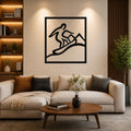 Black metal wall art with a minimalist silhouette of a snowboarder in motion, mounted above a beige sofa in a living room.