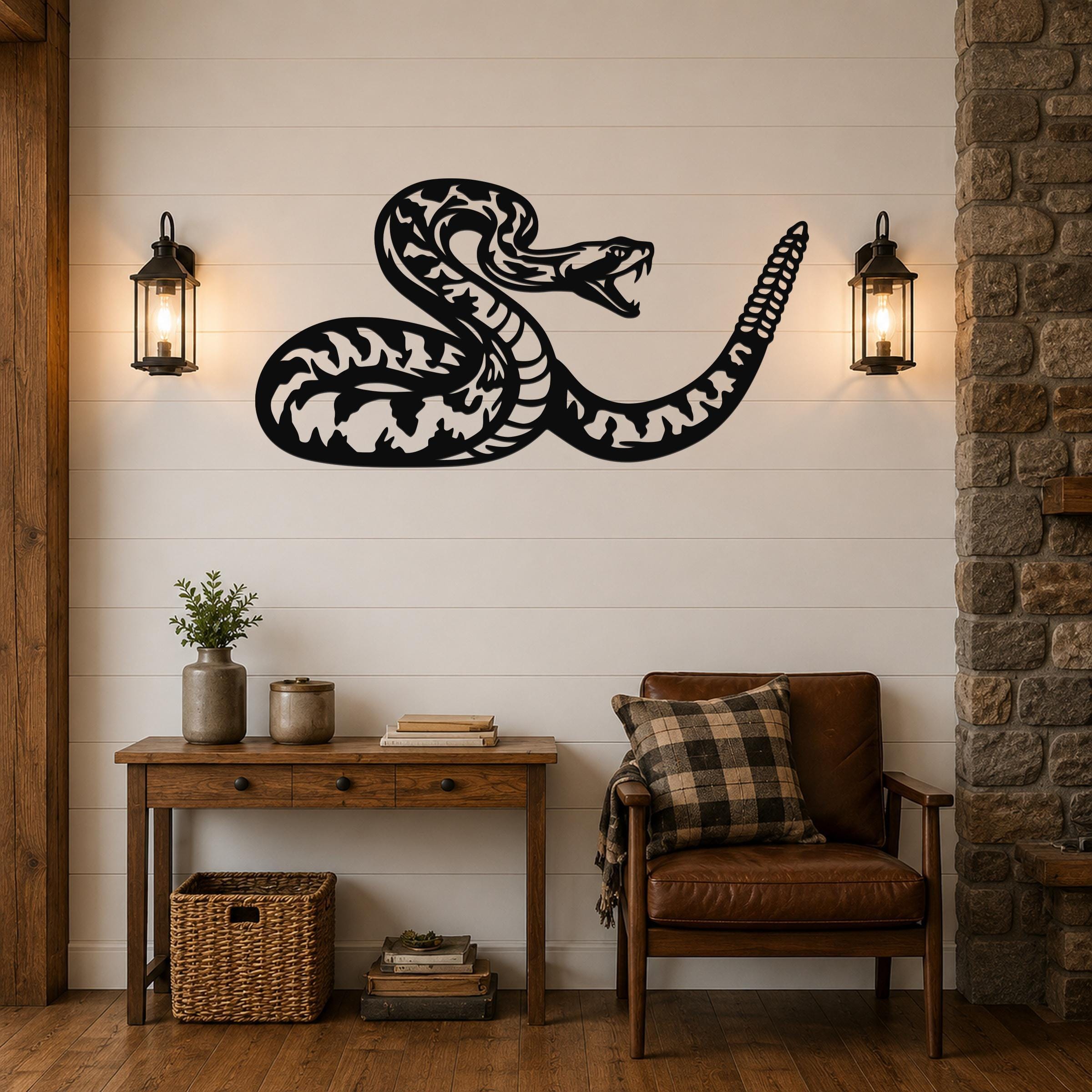 Black metal snake wall art with intricate internal cutouts, mounted on a shiplap wall above a wooden console table in a living room.