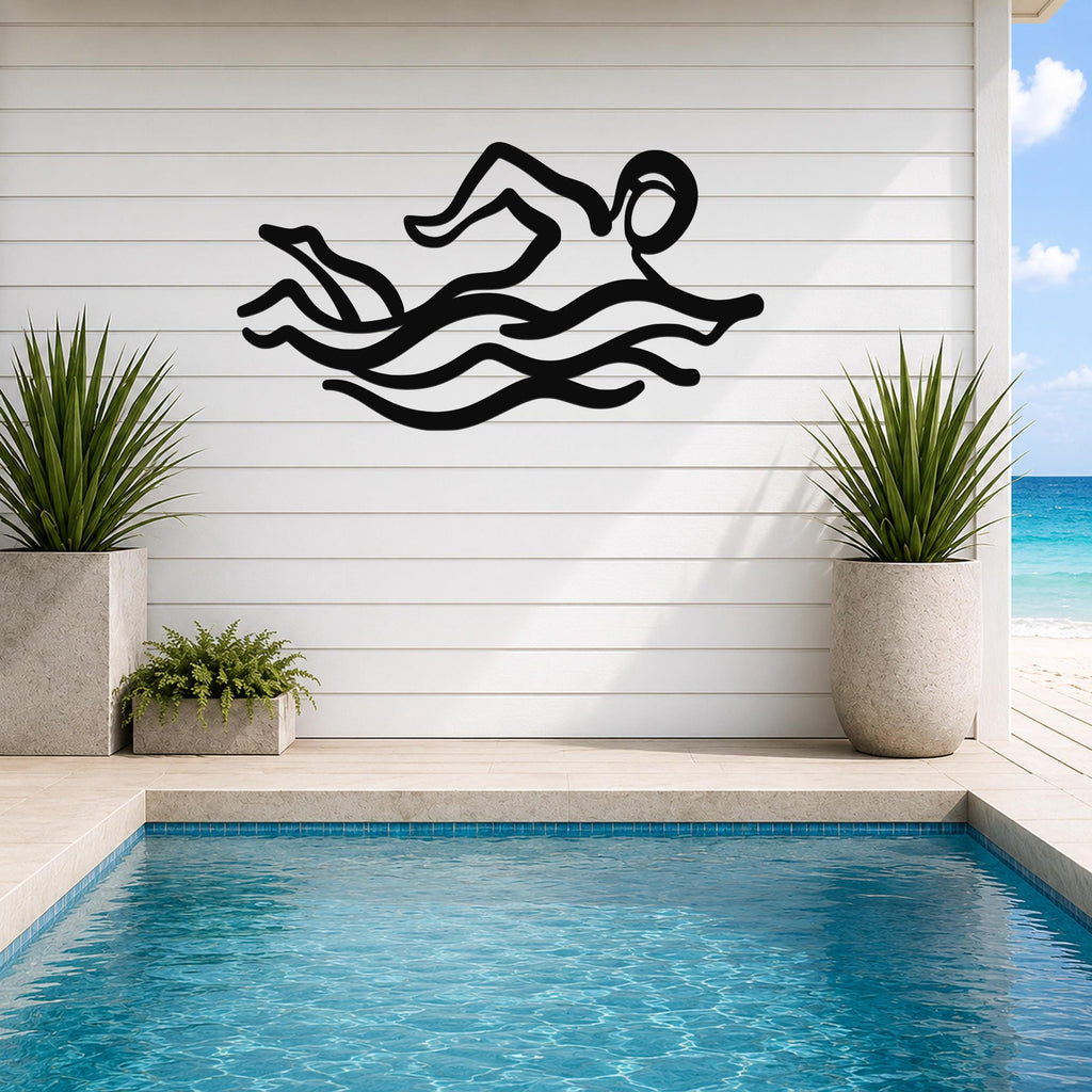 Black metal swimmer wall art with motion-line cutouts, mounted on a white shiplap wall above a pool in a patio setting.