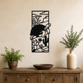 Black metal wall art featuring a tortoise silhouette climbing over cacti and desert plants, mounted on a beige wall above a wooden console table.