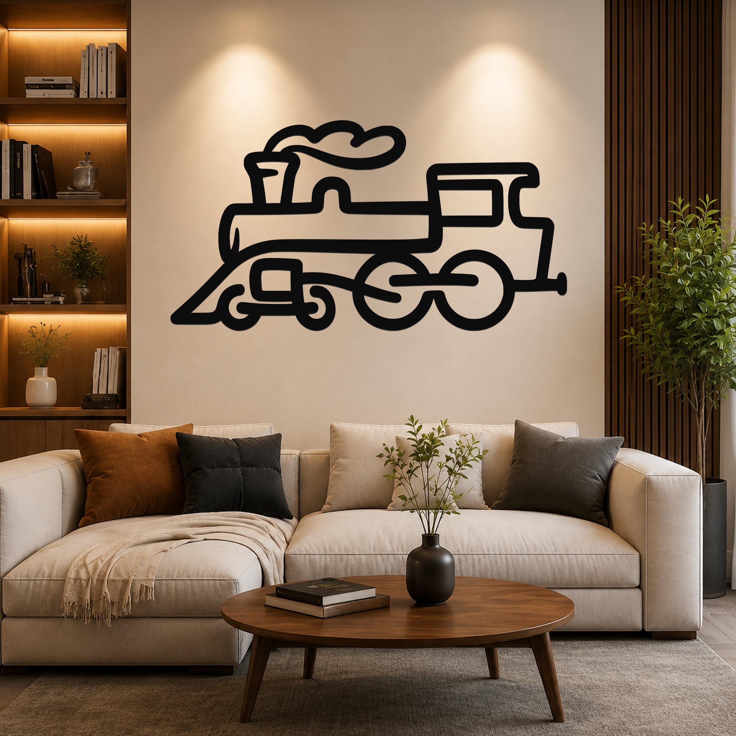 Black metal train wall art with a bold silhouette design, mounted above a beige sofa in a modern living room.