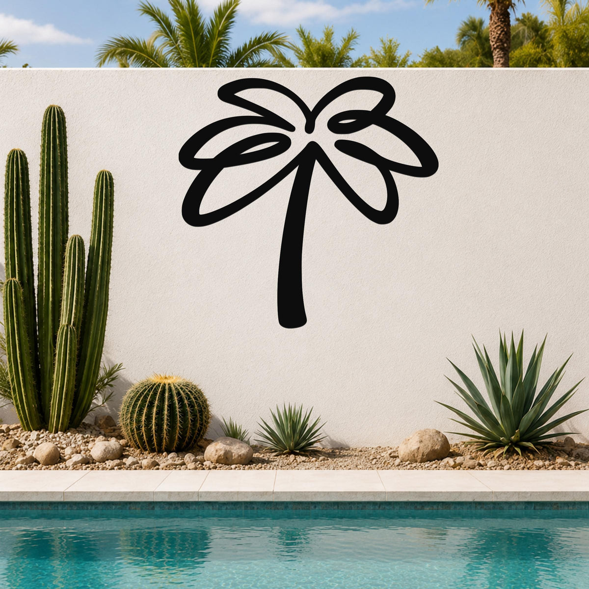 Black metal palm tree wall art with flowing frond cutouts, mounted on a white outdoor wall above a pool with cacti and succulents.