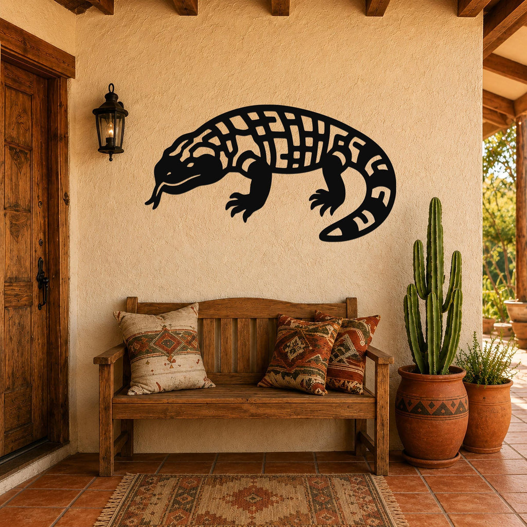 Black metal Gila monster wall art with geometric cutout patterns, mounted on a stucco wall above a wooden bench in a southwestern-style entryway.