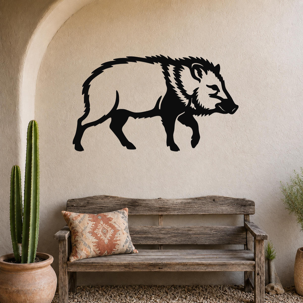Black metal javelina wall art silhouette mounted on a textured beige wall above a rustic wooden bench in a southwestern-style entryway.