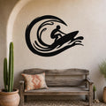 Black metal surfer wall art with wave cutouts, mounted above a wooden bench in a coastal-style entryway.