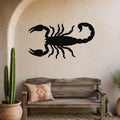 Black metal scorpion wall art silhouette mounted on a textured beige wall above a rustic wooden bench in a desert-themed entryway.