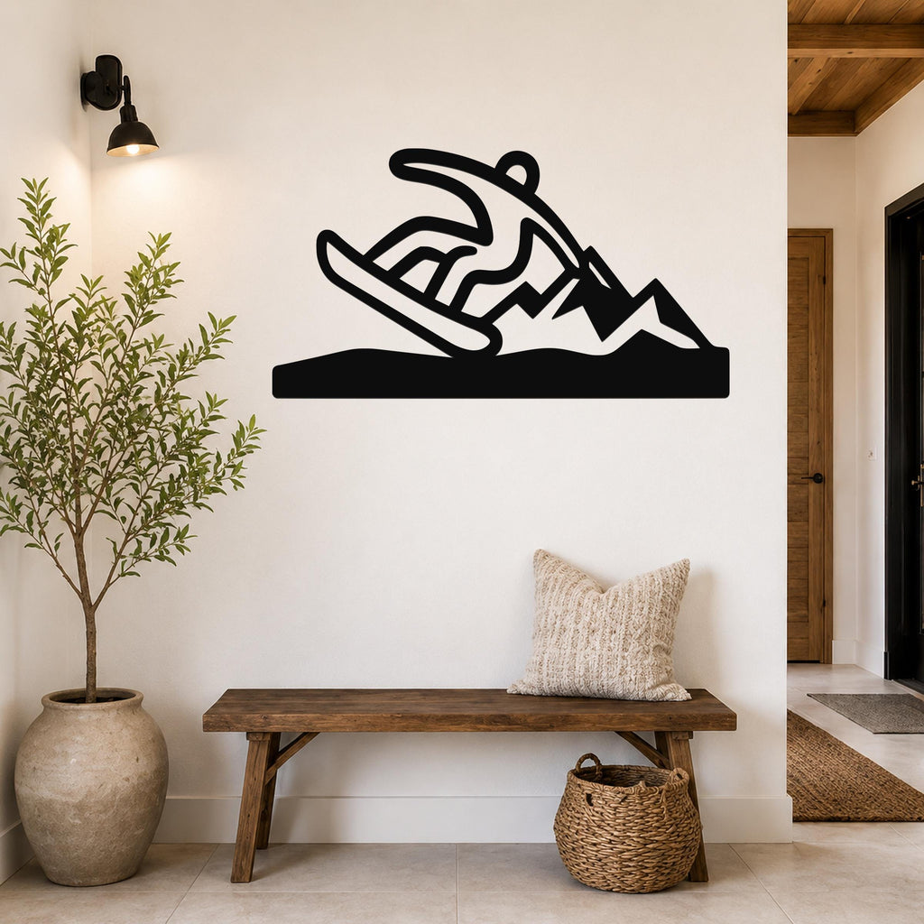 Black metal wall sculpture of a snowboarder in motion, mounted above a wooden bench in a modern entryway.