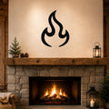 Black metal flame wall art with a bold silhouette design, mounted above a stone fireplace in a rustic living room.
