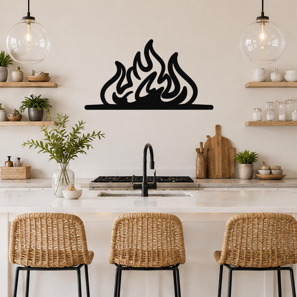 Black metal flame silhouette wall art with fluid, layered cutouts, mounted above a kitchen counter between two glass pendant lights.