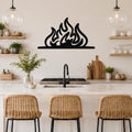 Black metal flame silhouette wall art with fluid, layered cutouts, mounted above a kitchen counter between two glass pendant lights.