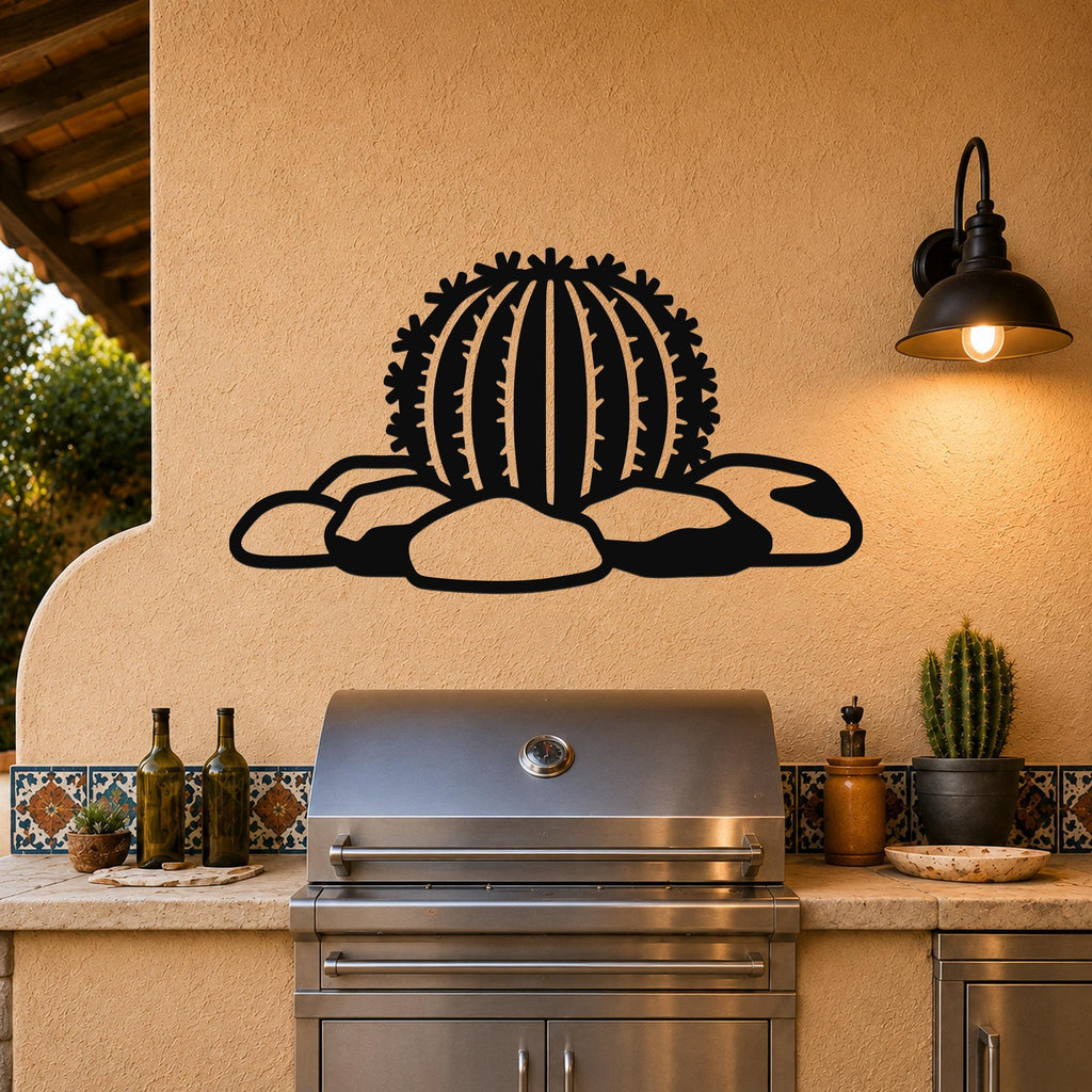 Black metal barrel cactus wall art with spines and rocks cutout, mounted on a stucco wall above a stainless steel grill on an outdoor patio.