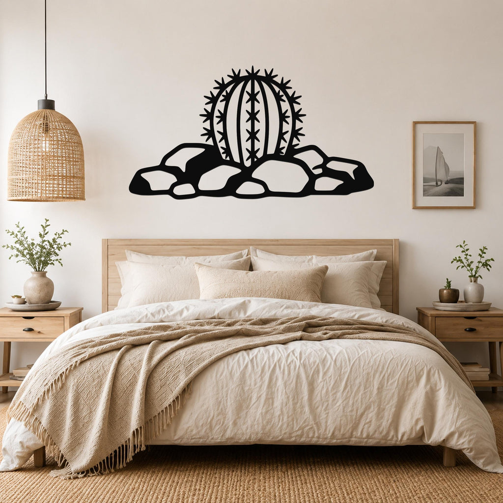 Black metal barrel cactus wall art with spines and rocks cutout, mounted above a bed in a neutral bedroom.