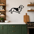 Black metal Basset Hound silhouette wall art mounted on a tiled kitchen wall above a white countertop.