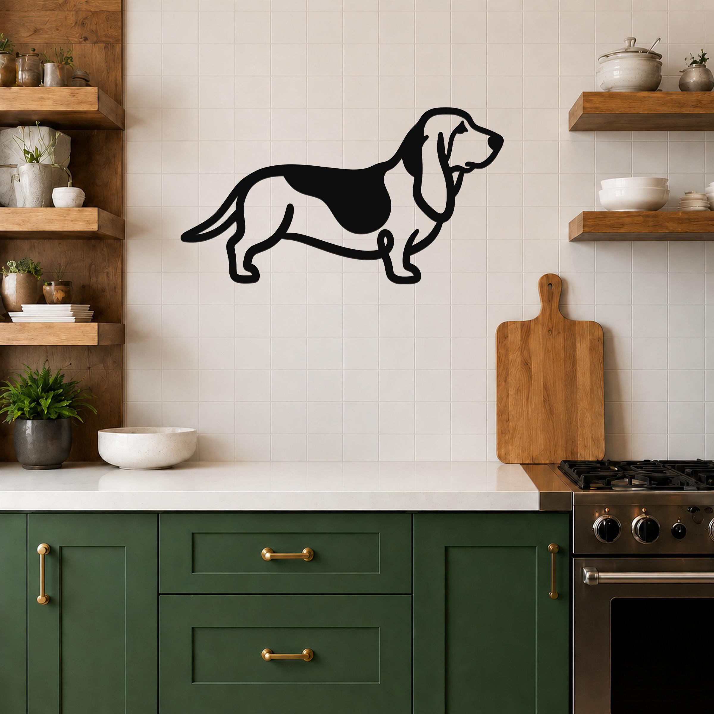 Black metal Basset Hound silhouette wall art mounted on a tiled kitchen wall above a white countertop.