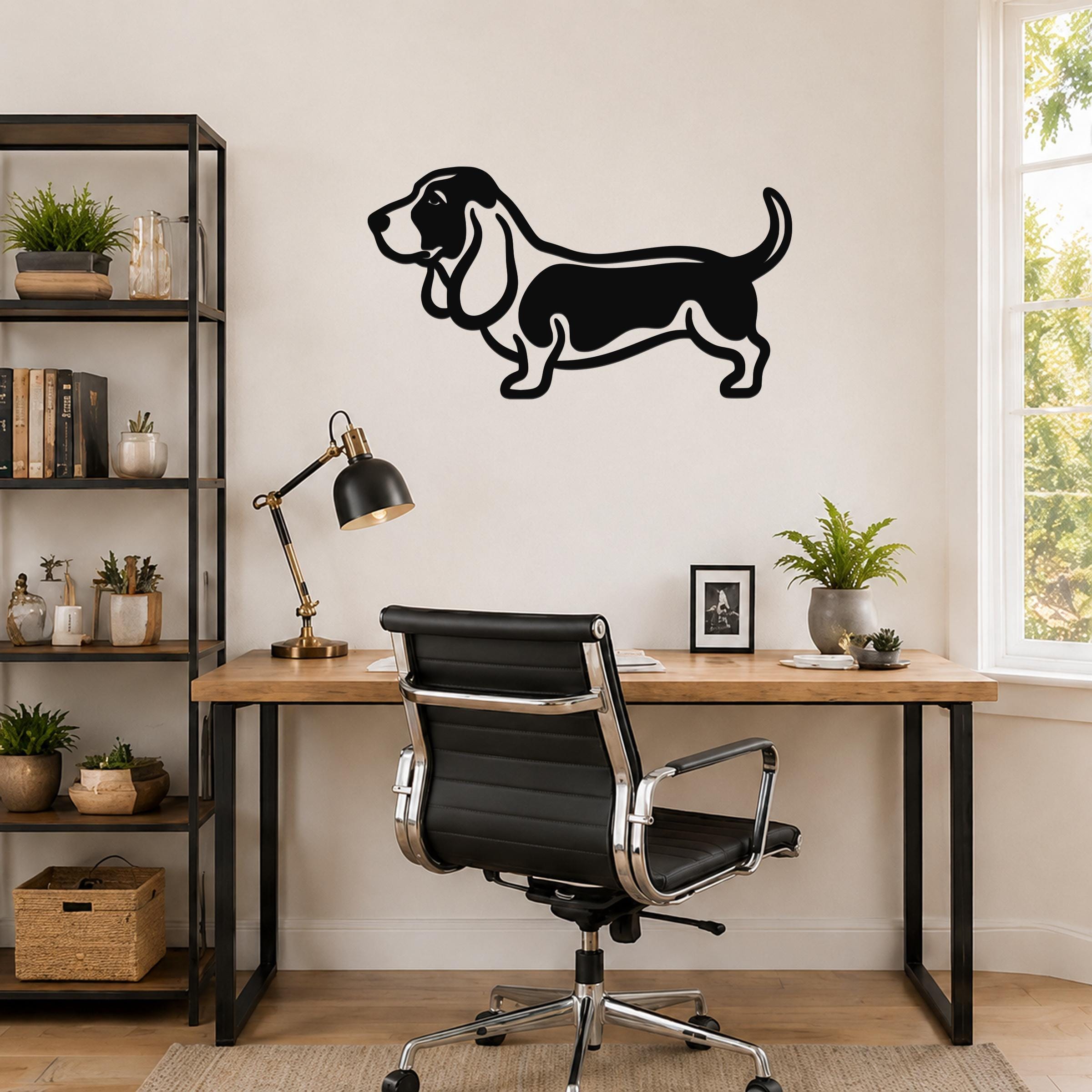 Black metal Basset Hound wall art silhouette mounted on a wall above a wooden desk in a home office.