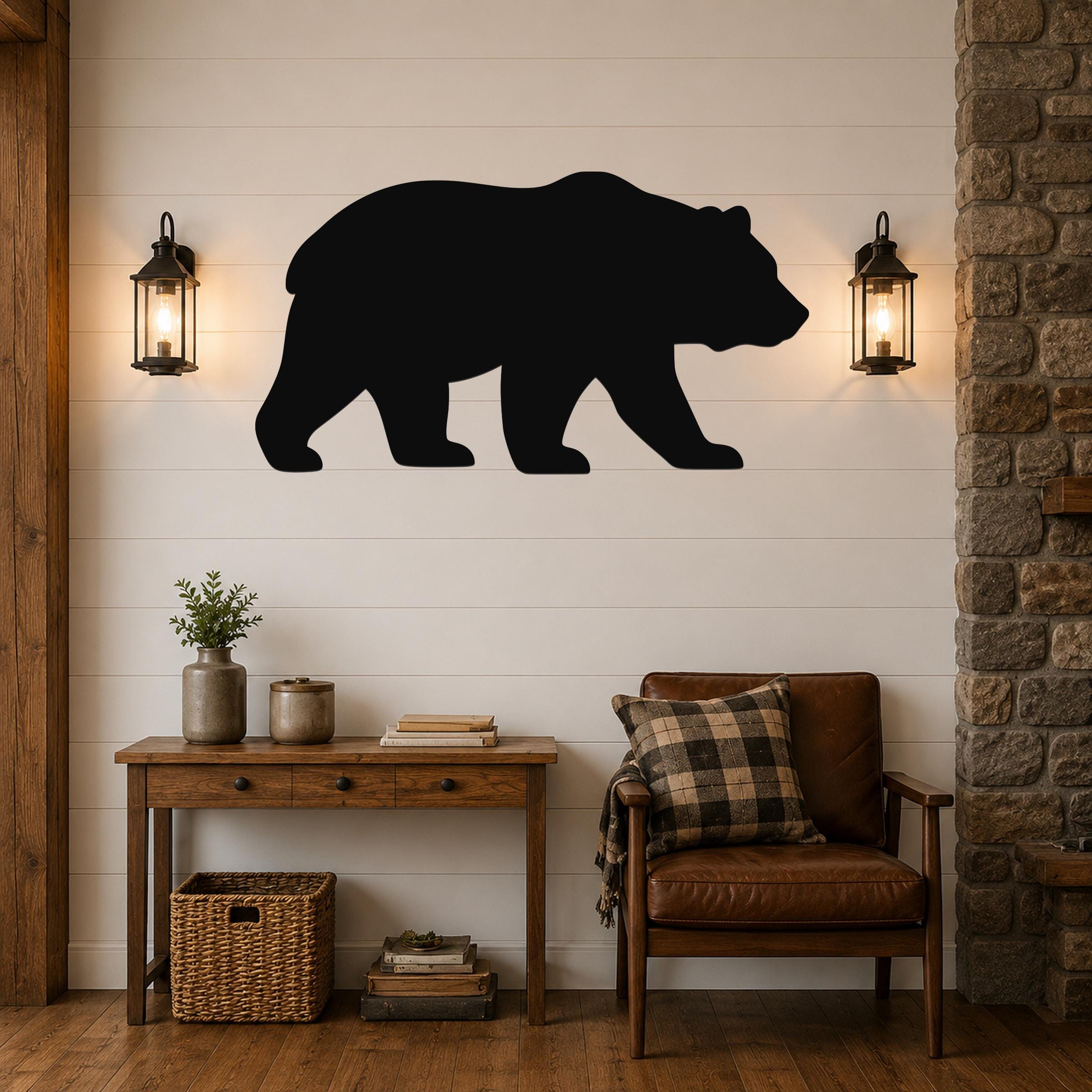 Black metal bear silhouette wall art mounted on a white shiplap wall above a wooden console table in a rustic living room.