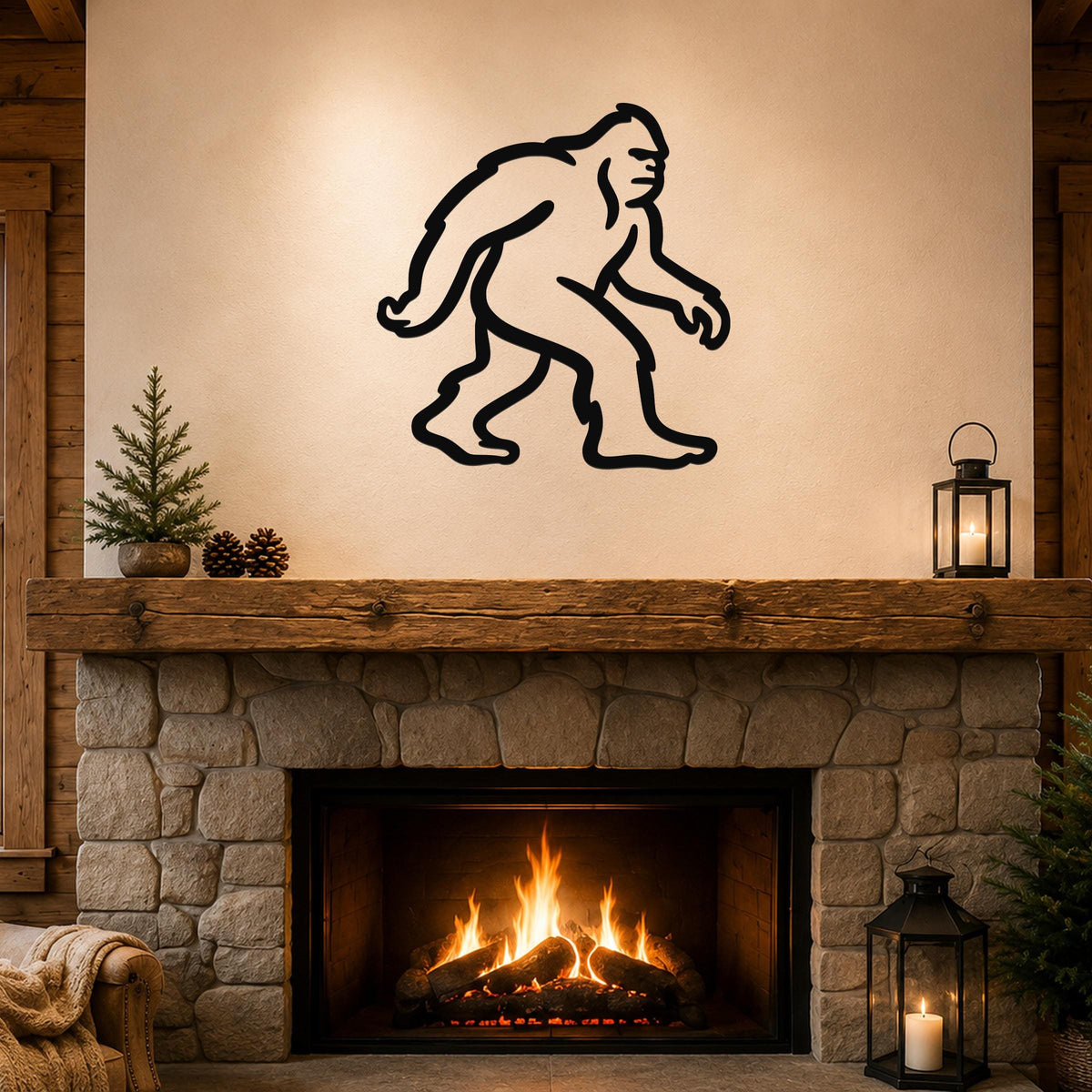 Black metal Bigfoot silhouette wall art mounted above a stone fireplace in a rustic living room.