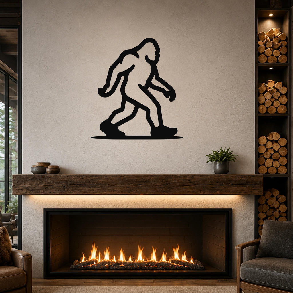 Black metal Bigfoot wall art silhouette mounted above a fireplace in a living room.