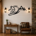 Black metal wall art silhouette of a snowboarder carving through powder with mountain peaks, mounted on a shiplap wall above a wooden console table in a living room.