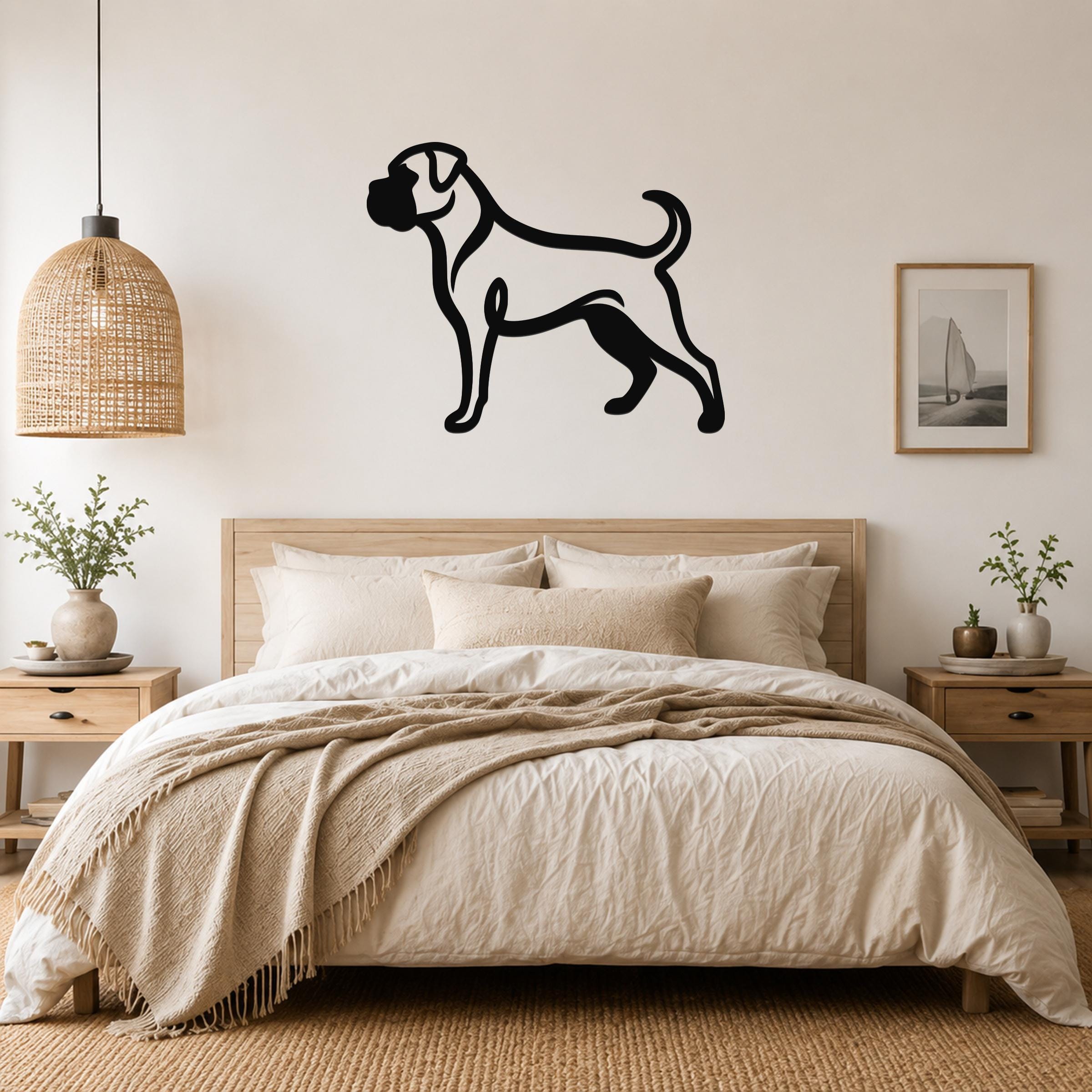Black metal Boxer dog silhouette wall art mounted above a bed in a neutral bedroom.