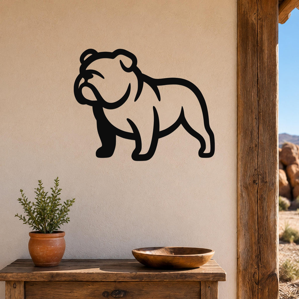 Black metal bulldog wall art silhouette mounted on a beige wall above a wooden table with a potted plant and bowl, suitable for indoor or outdoor use.