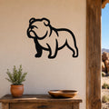 Black metal bulldog wall art silhouette mounted on a beige wall above a wooden table with a potted plant and bowl, suitable for indoor or outdoor use.