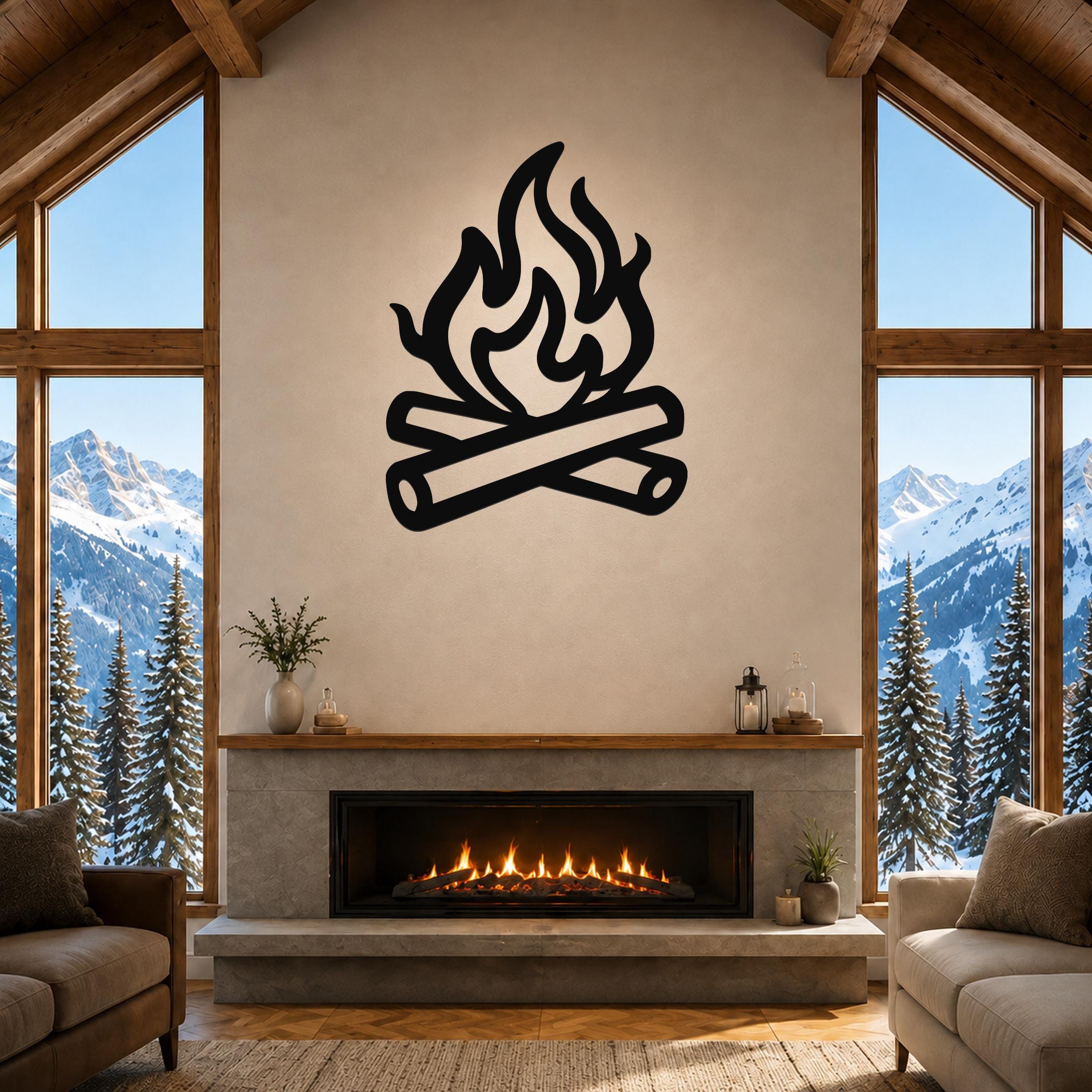 Black metal campfire wall art with flame and log silhouette, mounted above a fireplace in a rustic living room with mountain views.