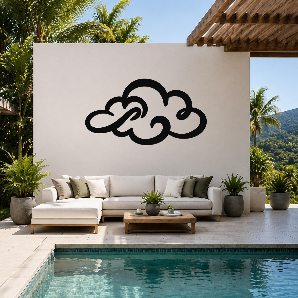 Black metal cloud wall art with flowing silhouette cutouts, mounted on a white outdoor wall above a white sectional sofa in a patio setting.