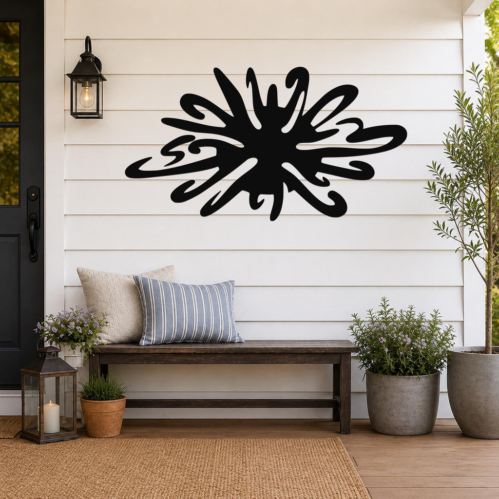 Black metal sea urchin wall art with organic spines and cutout details, mounted on a white shiplap wall above a wooden bench on a porch.