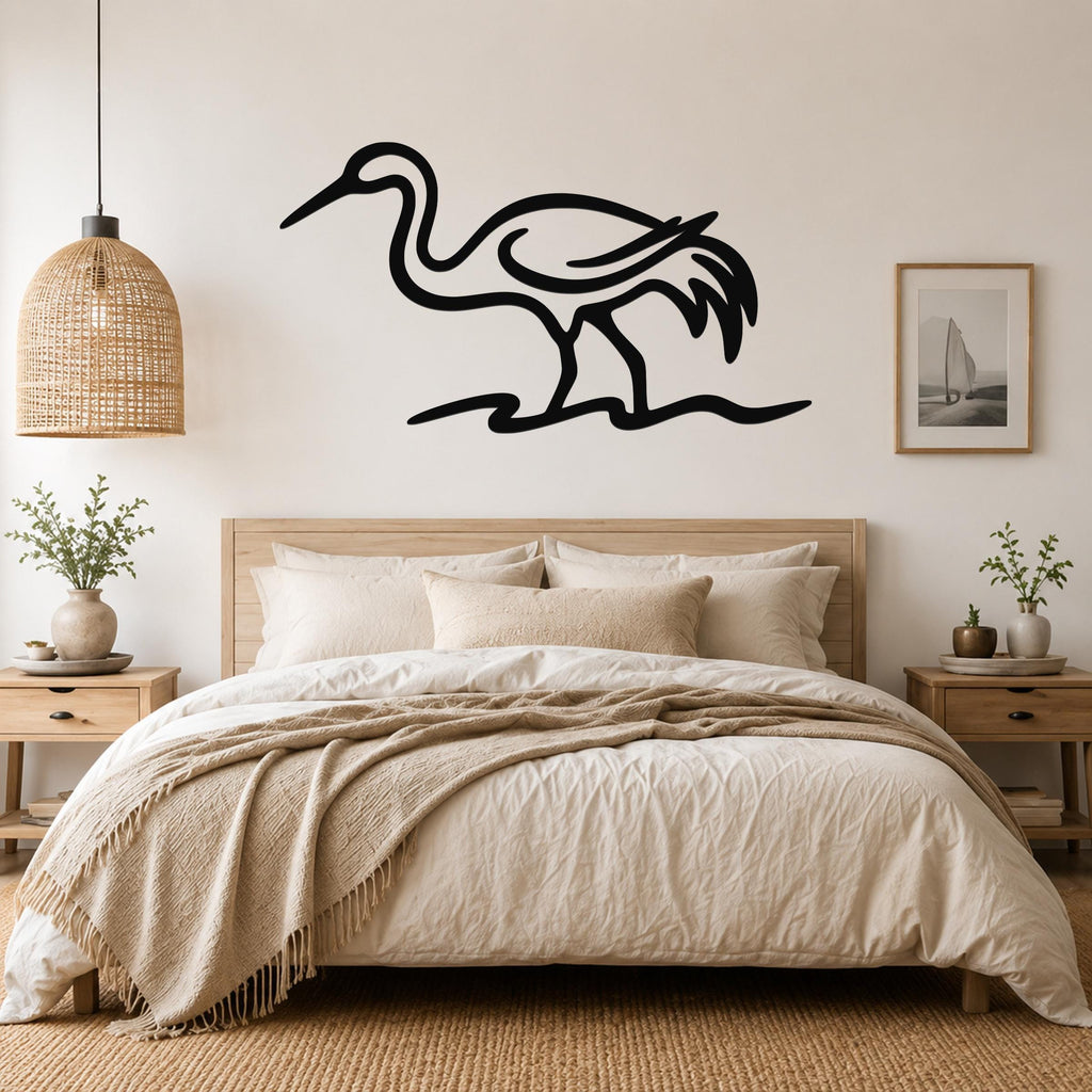 Black metal crane wall art with flowing line cutouts, mounted above a bed in a neutral bedroom.