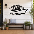 Black metal cruise ship wall art with motion-line cutouts, mounted on a white shiplap wall above a wooden bench on a porch.