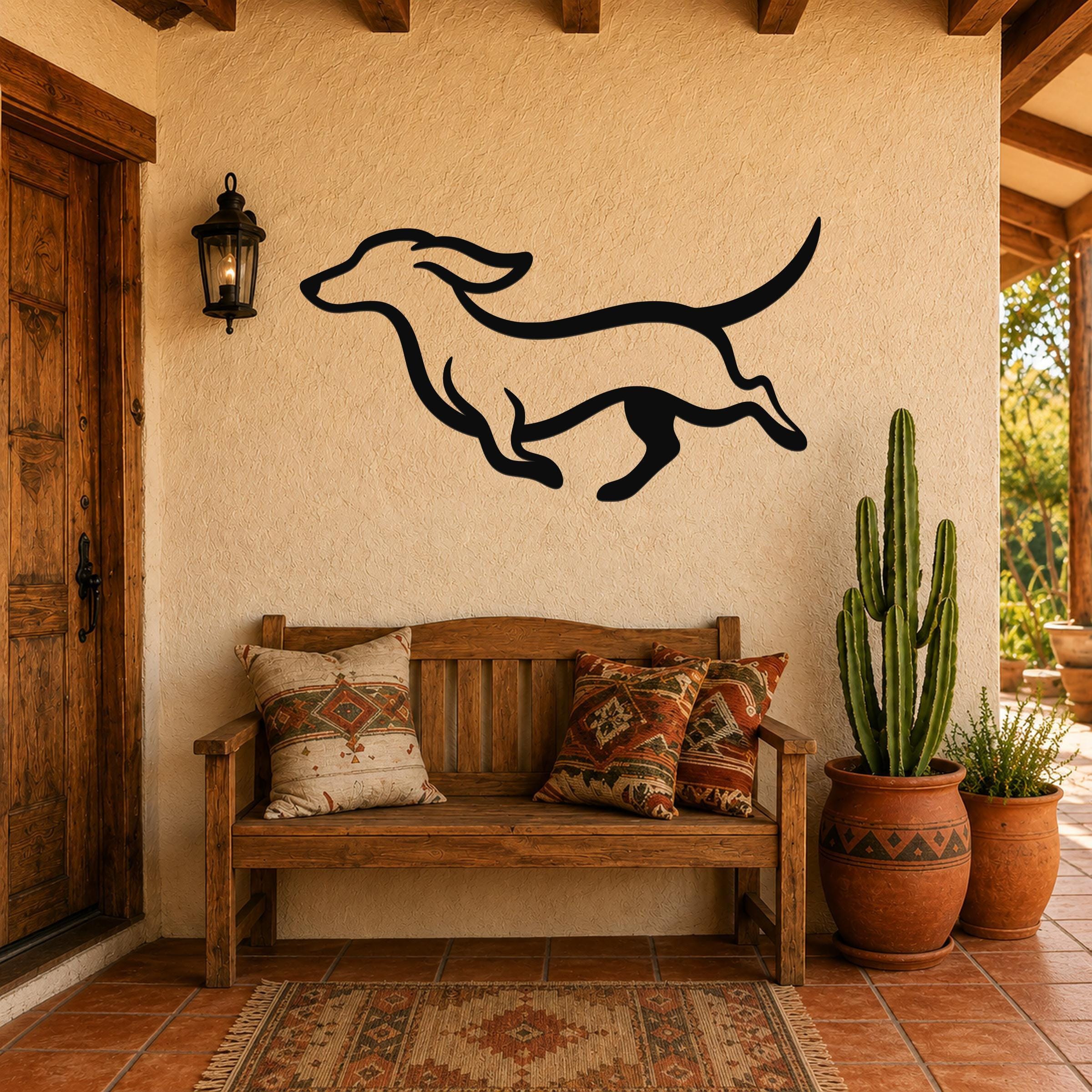 Black metal dachshund wall art with bold silhouette lines, mounted on a stucco wall above a wooden bench in a patio entryway.