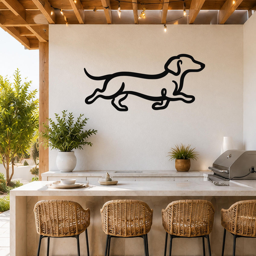 Black metal dachshund wall art with a running silhouette, mounted on a white outdoor wall above a kitchen counter.
