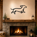 Black metal dachshund wall art with motion-line cutouts, mounted above a stone fireplace in a living room.