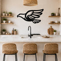 Black metal eagle wall art with a bold silhouette and wing cutouts, mounted on a kitchen wall above a counter.