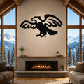 Black metal eagle wall art with outstretched wings and detailed silhouette, mounted above a fireplace in a rustic living room with mountain views.
