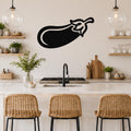 Black metal eggplant wall art with a bold silhouette design, mounted on a kitchen wall above a counter with wicker bar stools.