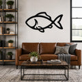 Black metal fish wall art with bold silhouette lines, mounted above a brown leather sofa in a living room.