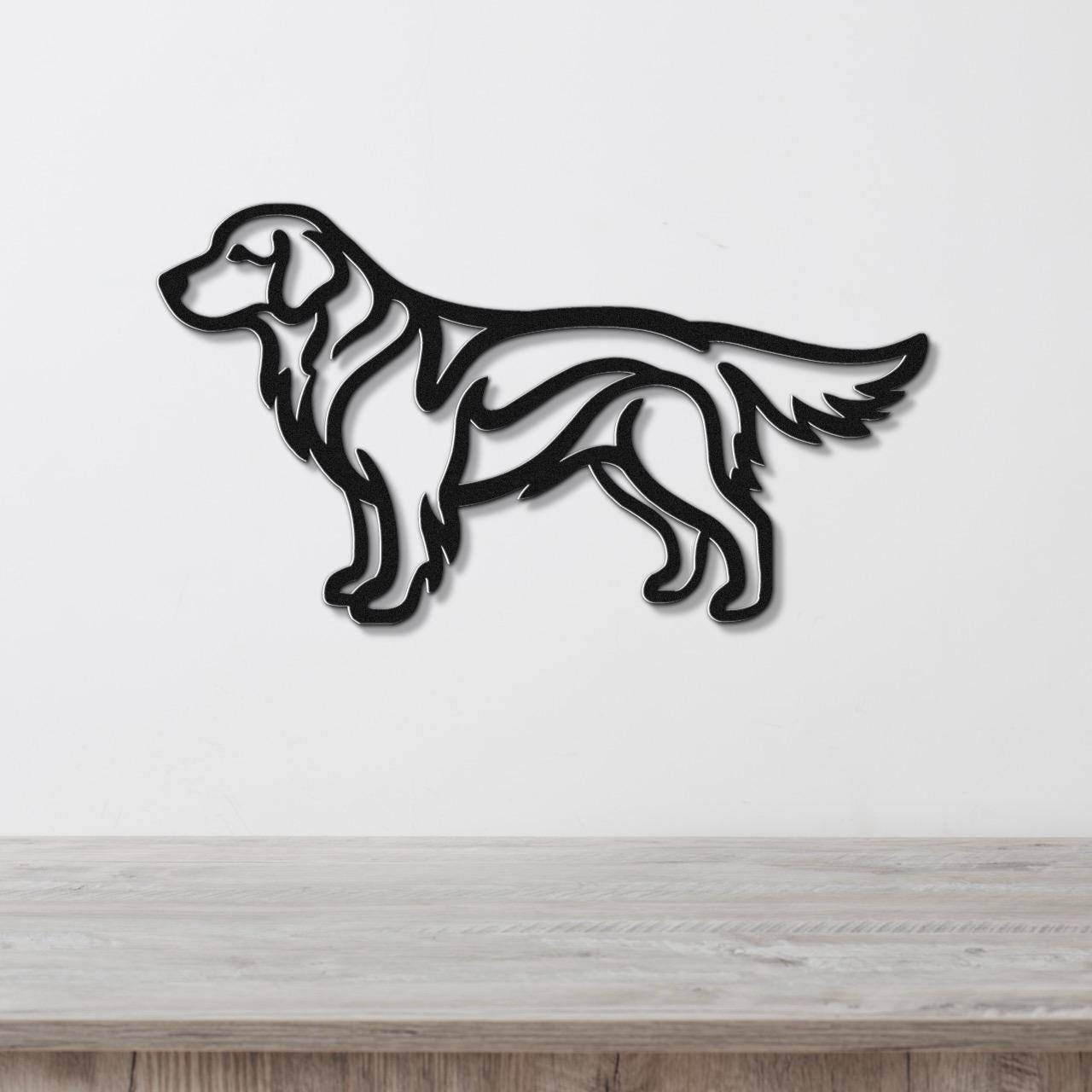 Black metal wall art in the silhouette of a standing golden retriever, mounted on a white wall above a light wood surface.
